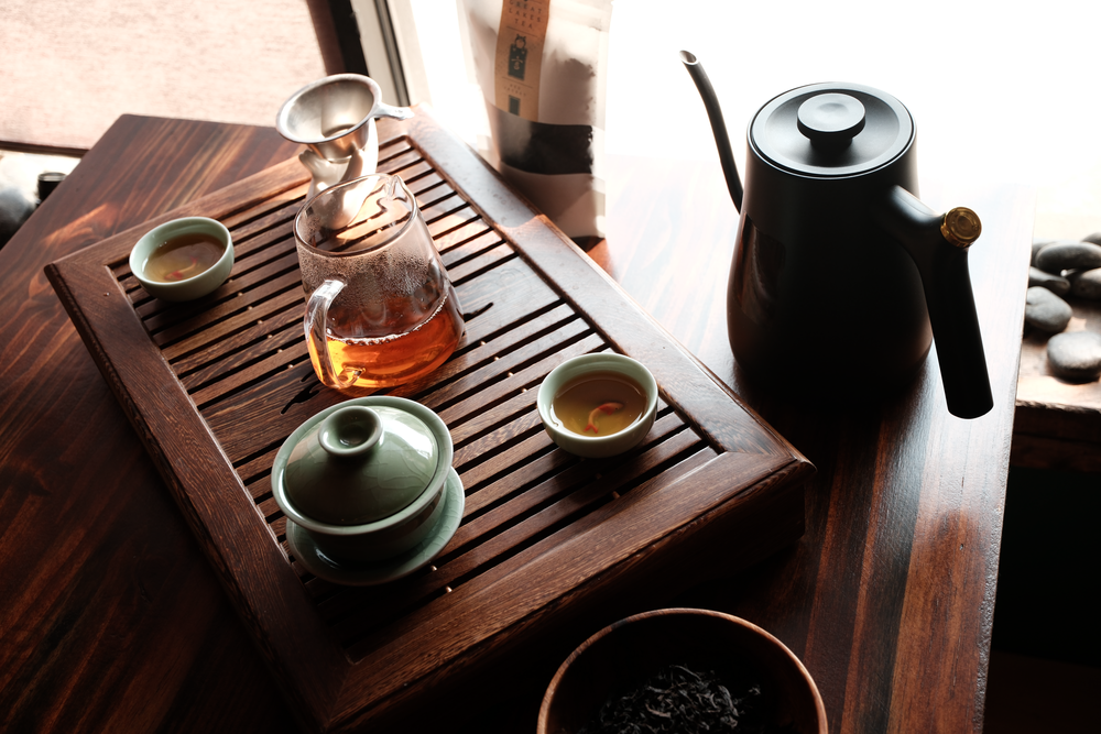 A tray with traditional chinese tea brewing equipment.